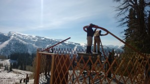 Placing the rafter pins in the Center Ring at Baldy Knoll Yurt